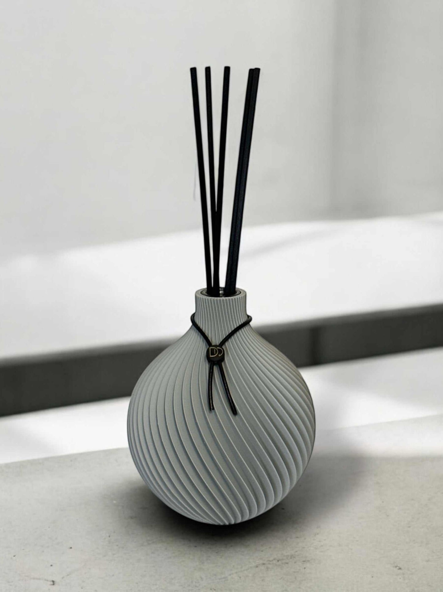Elegant globe-shaped diffuser with 3D printed design.