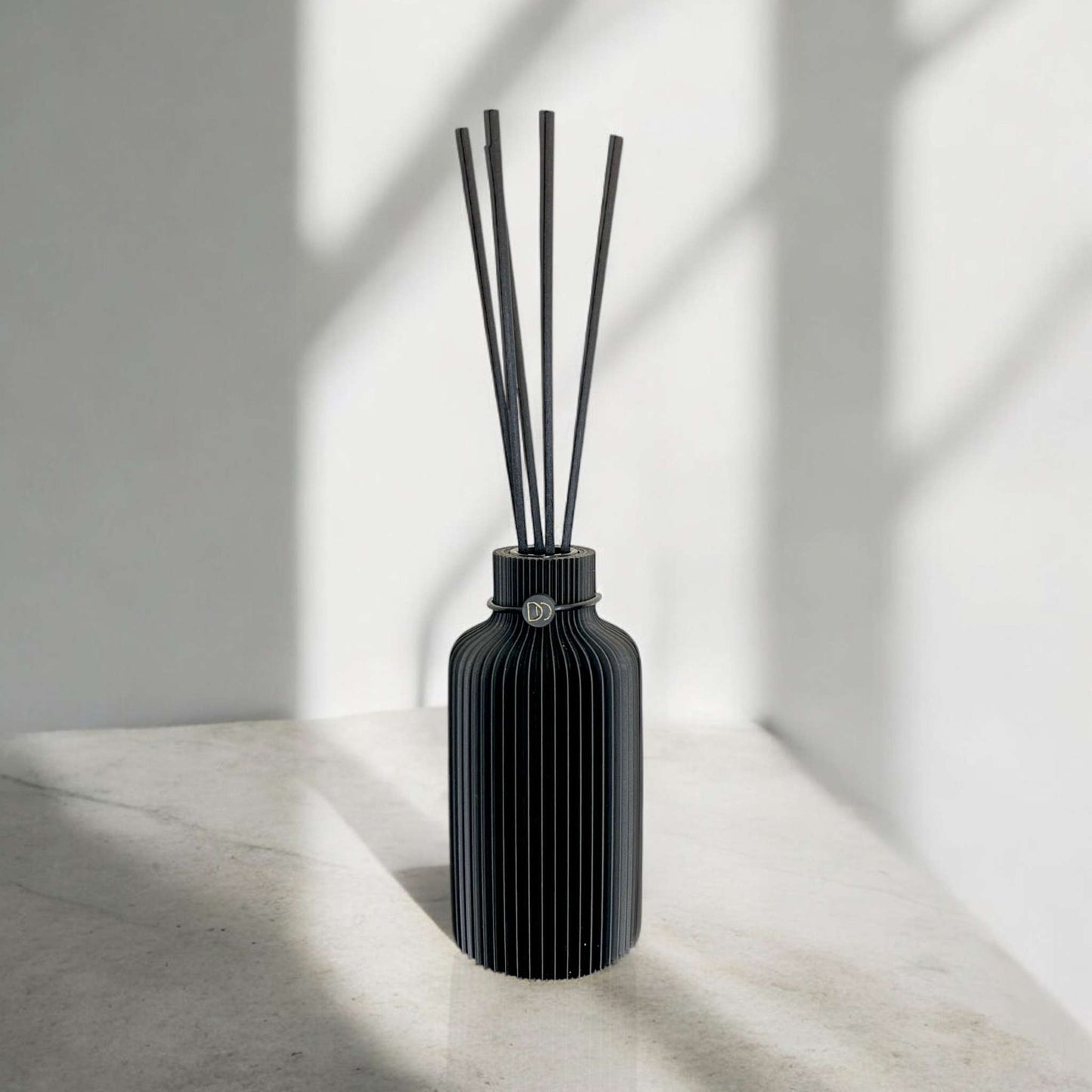 Minimalist diffuser with elegant, 3D-printed black design for sophisticated fragrance diffusion.