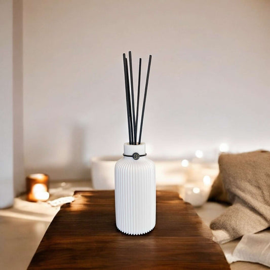 Elegant minimalist diffuser on wooden table, adding sophistication and fragrance to interior space.