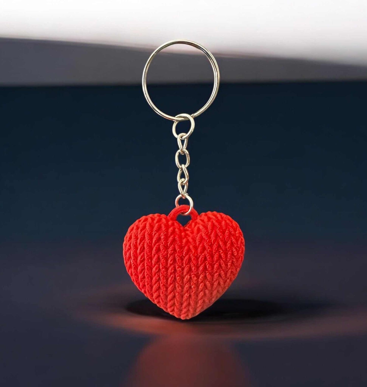 Heart-shaped knitted keychain with realistic texture, 3D printed for durability.